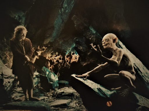 “So You Know About Our Little Footpad, Do You?” Gollum Follows The Fellowship Down The Anduin.