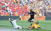  Luvuyo Memela of Orlando Pirates scoring his goal past Itumeleng Khune and Siyabonga Ngezana of Kaizer Chiefs during the Absa Premiership match between Orlando Pirates and Kaizer Chiefs at FNB Stadium on March 03, 2018 in Johannesburg.