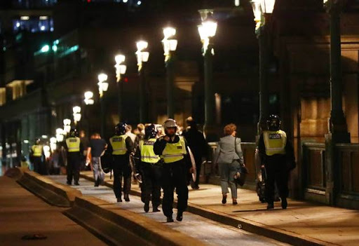 Police officers cross Southwark Bridge after an incident near London Bridge in London, Britain June 4, 2017.