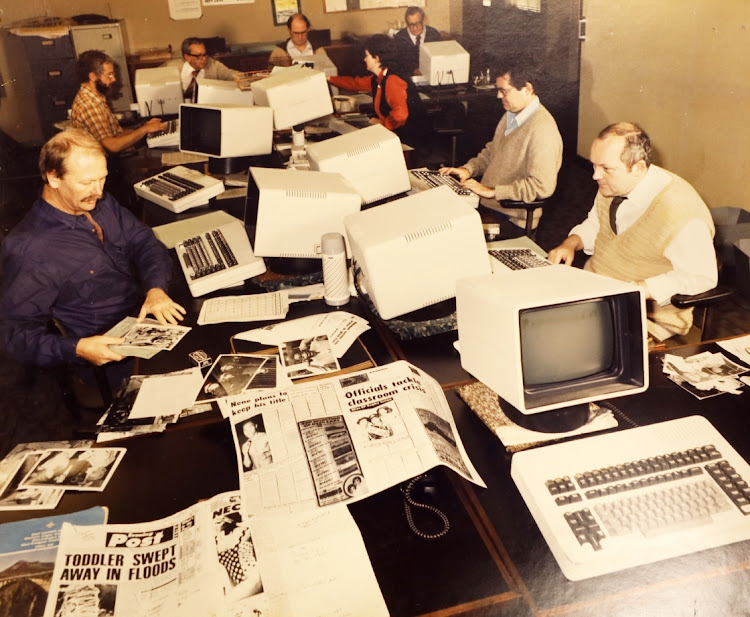 The Evening Post and Weekend Post subs room in the early 1980s. Clockwise from left, around the table, are Evening Post chief sub Cal Seton-Smith, the late Arthur Geldenhuys, the late Harland Bohler, Keith Dimbleby, the late Stan Gray, Weekend Post chief sub Susan Stead, Stephen Rowles and the late Bob Kernohan. The papers then used the mainframe computer Atex operating system