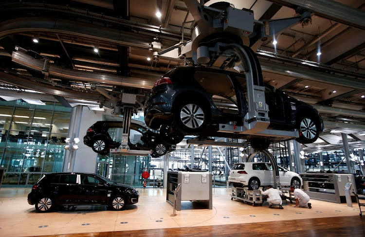 Workers assemble an e-Golf electric car at the new production line of the Transparent Factory of German carmaker Volkswagen in Dresden, Germany March 30, 2017.