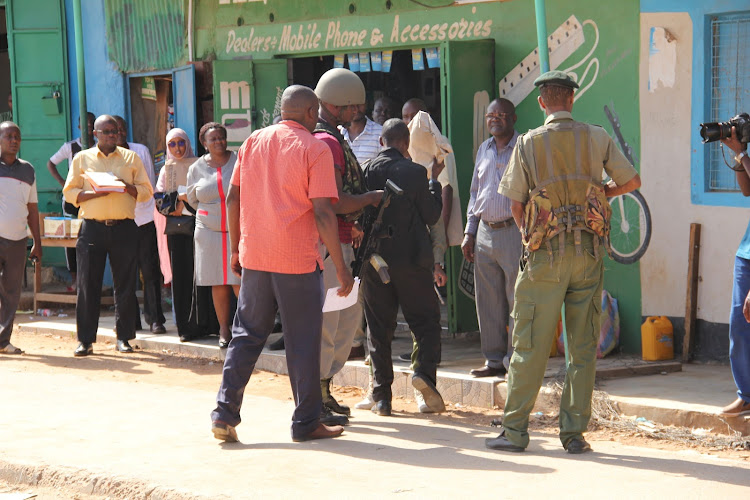 Issack Robow, the driver of the abducted Cuban doctors, is led by police to the scene of crime for an open court hearing