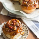 Bourbon-Maple Bacon Sticky Buns was pinched from <a href="http://www.crumbblog.com/bourbon-maple-bacon-sticky-buns/" target="_blank" rel="noopener">www.crumbblog.com.</a>