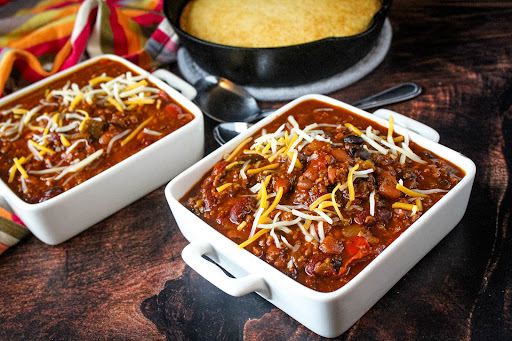 Bowl of Super Bowl Award Winning Chili with shredded cheese.