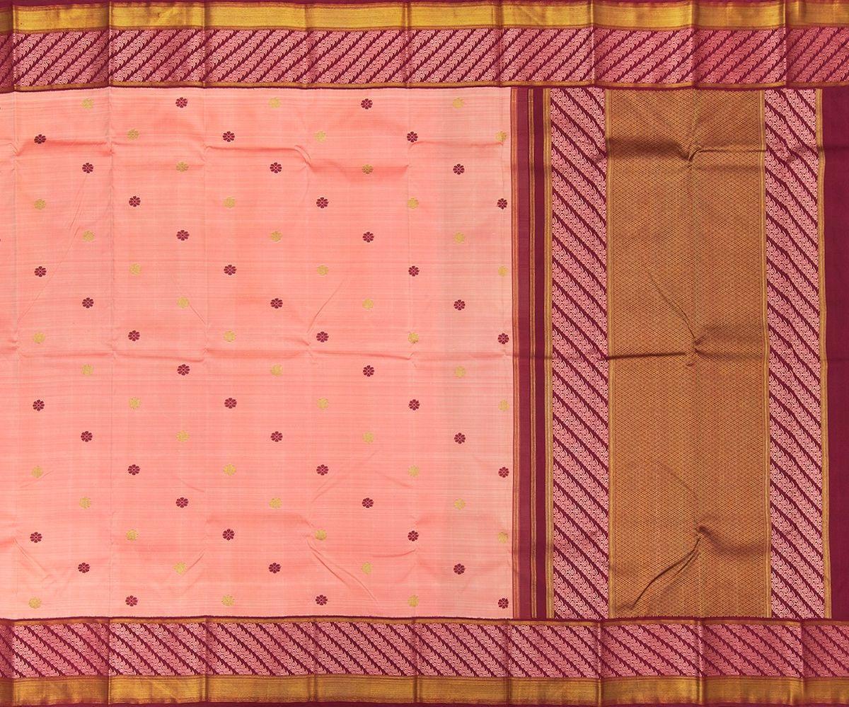 The eight-petalled kamalam motif occurs throughout this handloom Kanchipuram silk saree that’s naturally-dyed with sappan wood. 