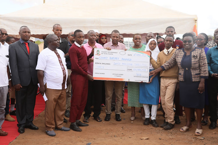 Taita Taveta Governor Andrew Mwadime with his Deputy Christine Kilalo during the launch of county bursary programme in Taveta on April 12