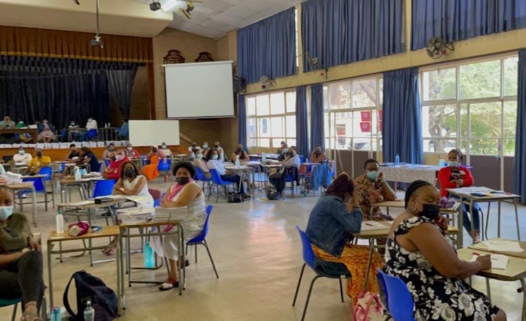 Staff who fled the storm-damaged matric marking centre in Thaba-Nchu on Wednesday resume work at HTS Louis Botha High School in Bloemfontein on December 18 2021.