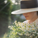 Girl hat daisy flowers