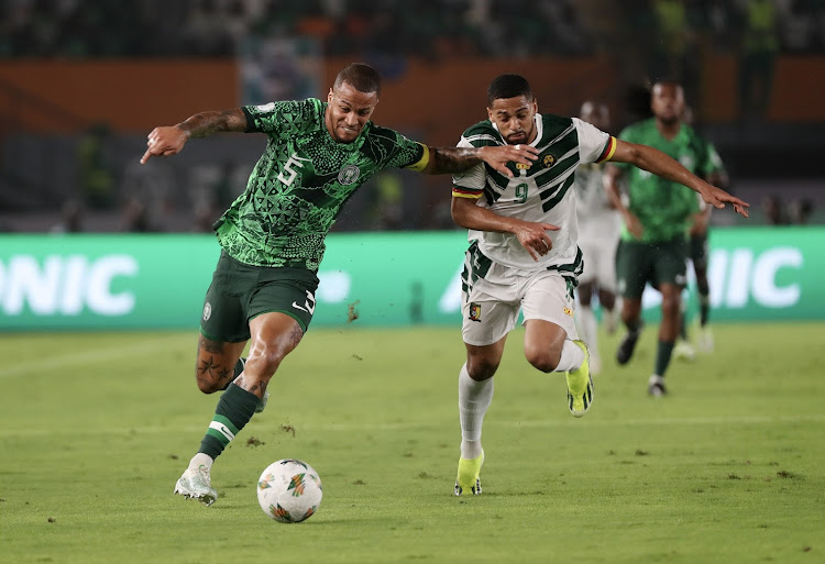 William Ekong of Nigeria challenged by Frank Magri of Cameroon during their Africa Cup of Nations (Afcon) last 16 match at the Felix Houphouet Boigny Stadium in Abidjan.