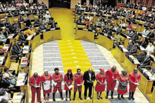 RED PERIL: EFF members take the oath of office during the swearing-in of members of parliament Photo: DOC media