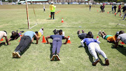 Potential recruits are taken through their paces during a fitness exercise at  Modderbee Correctional Services, Benoni. 