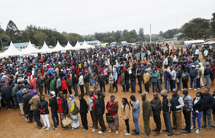 Voters queue before casting their ballots during the general election by the Independent Electoral and Boundaries Commission (IEBC) in Kibera slums of Nairobi, Kenya on August 9, 2022.