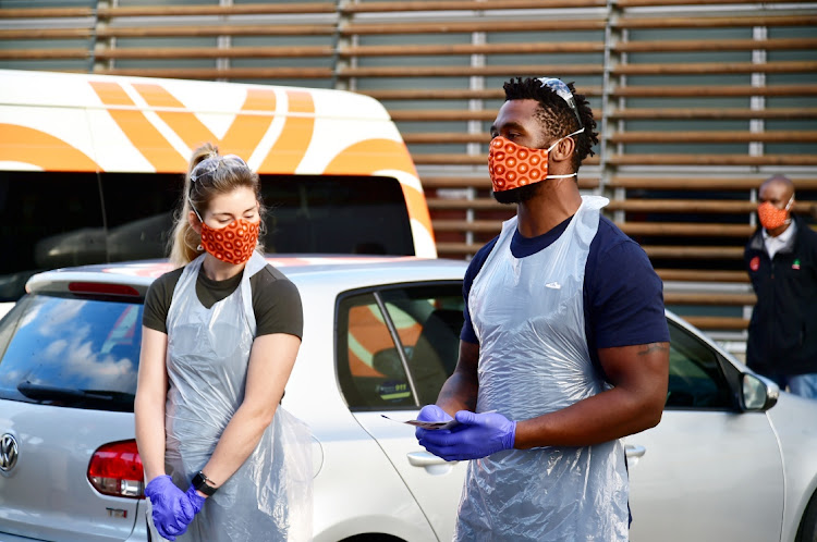 POWER COUPLE: Springbok rugby captain Siya Kolisi, and his wife Rachel, led a team of organisations that dished out hundreds of food parcels in Zwide in April 2020