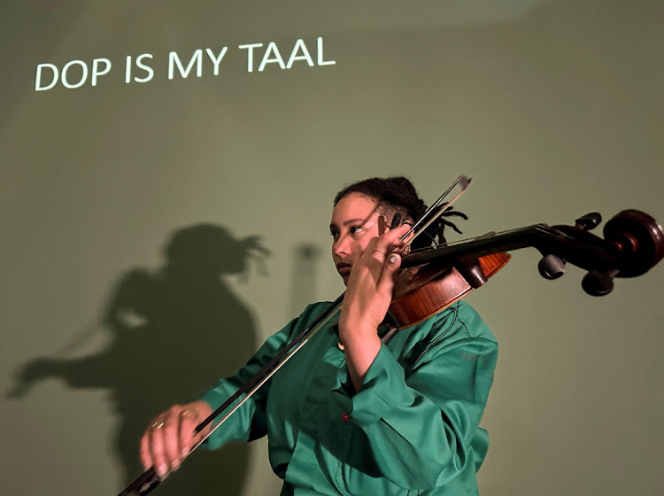 SA violist Lynn 'Daphne' Rudolph, who uses music and art to explore the painful legacy of the 'dop system', during a rehearsal at an arts venue in Johannesburg.