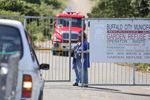 ENGULFED IN SMOKE: A fire truck makes its way out of the Beacon Bay refuse site yesterday. A fire that started on Wednesday had some firms in the area closing early Picture: MARK ANDREWS