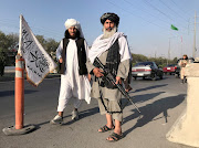 A Taliban fighter holding an M16 assault rifle stands outside the Interior Ministry in Kabul, Afghanistan on August 16, 2021.