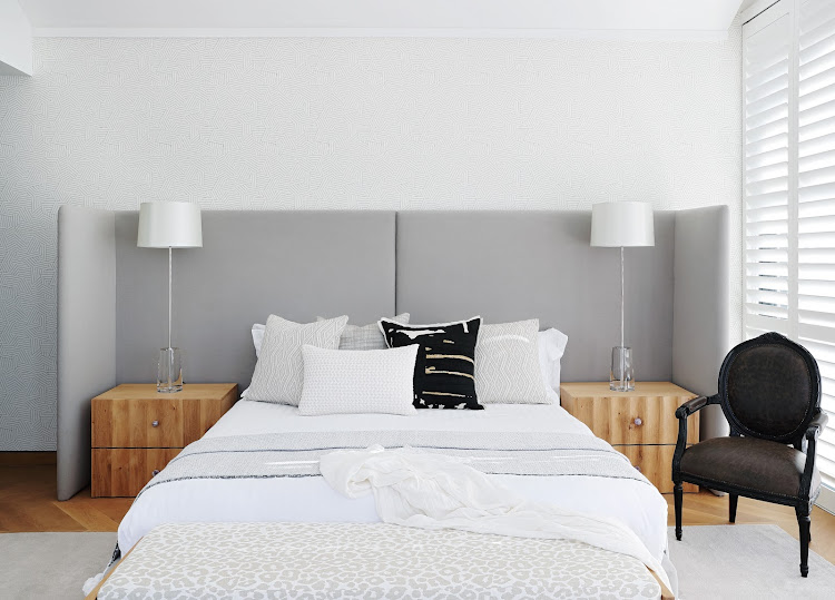 An oversized headboard envelopes the bedside tables in the master bedroom turning the bed into a statement piece.