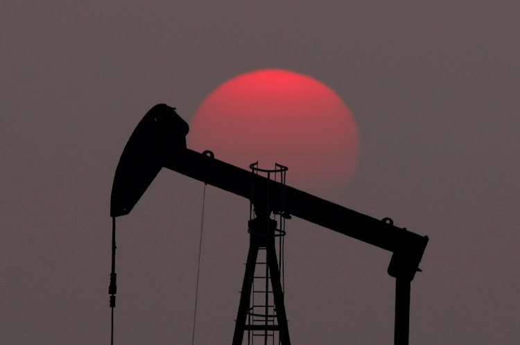 The sun sets behind an oil pump outside Saint-Fiacre, near Paris, France. Picture: REUTERS/CHRISTIAN HARTMANN