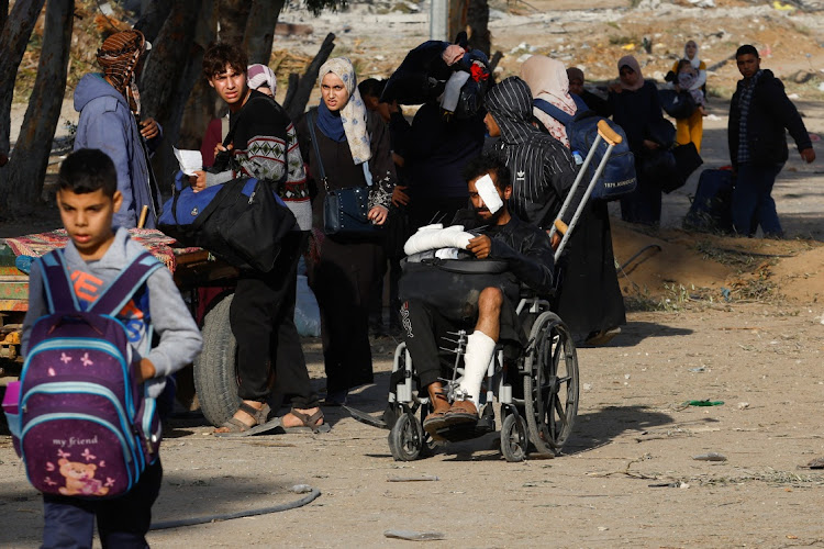 A Palestinian man sits on a wheelchair as he and others flee Gaza City, during a temporary truce between Israel and Hamas, near Gaza City, November 24 2023. Picture: IBRAHEEM ABU MUSTAFA