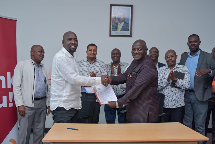 Roads and transport CS Kipchumba Murkomen and Uganda’s Minister of Works and Transport Edward Katumba Wamala pause for a photo after signing the deal on SGR extension financing