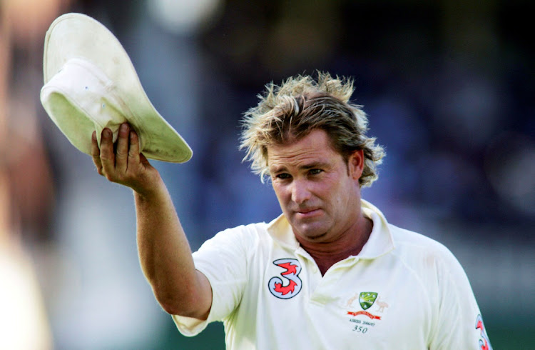 Australia's Shane Warne acknowledges the crowd after the wicket of England's Andrew Flintoff during the fifthTest at Sydney Cricket Ground in the 2006-07 series against England. File photo.