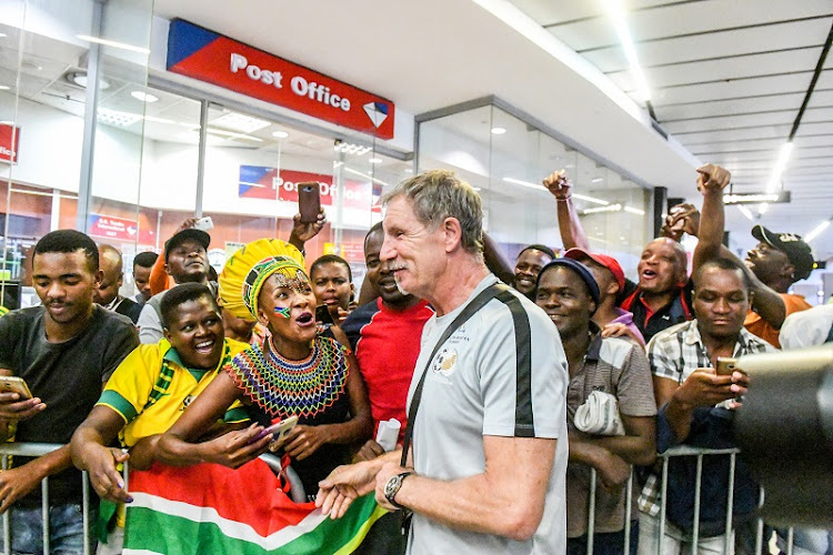 Bafana Bafana coach Stuart Baxter interacts with the supporters during at OR Tambo International Airport.