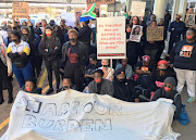 Protesters with sealed mouths outside WEF Africa on September 4 2019.