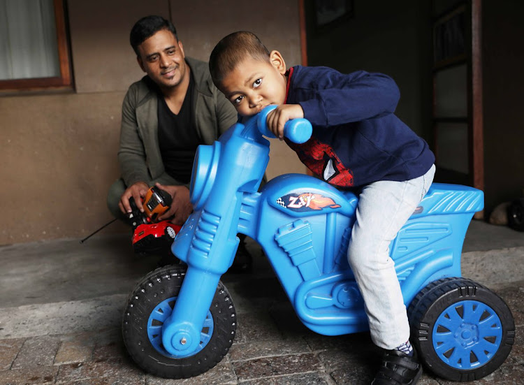 Ebrahim Kriel, who is undergoing treatment for acute myeloid leukaemia, plays with his scooter while his father Aabied looks on.