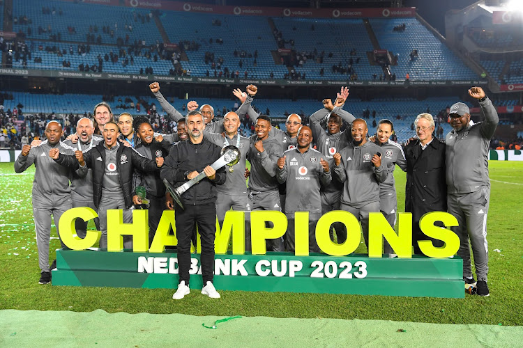 Orlando Pirates coach Jose Riveiro celebrates with his technical teams after the Nedbank Cup final against Sekhukhune United at Loftus Versfeld Stadium on March 27, 2023.