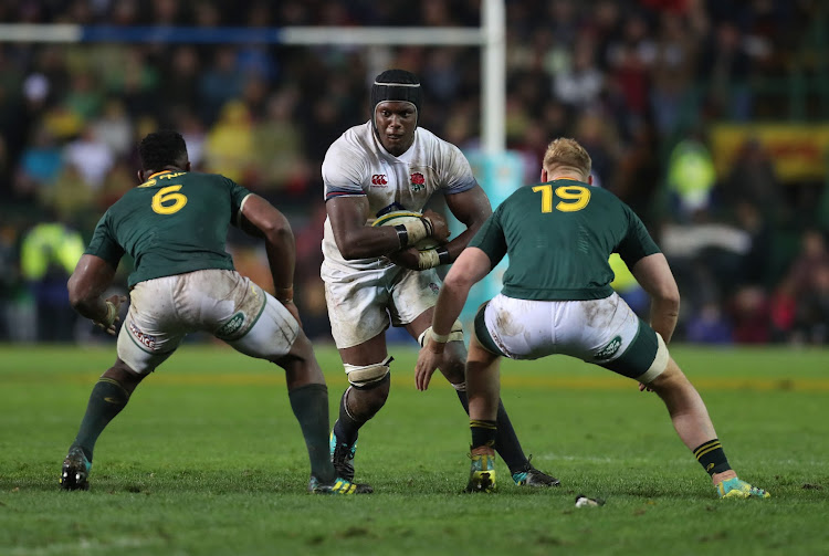 Maro Itoje of England goes into tackle with Siya Kolisi and Jean Luc du Preez of South Africa during of the international rugby match between the Springboks and England at Newlands Stadium in Cape Town on June 23, 2018.