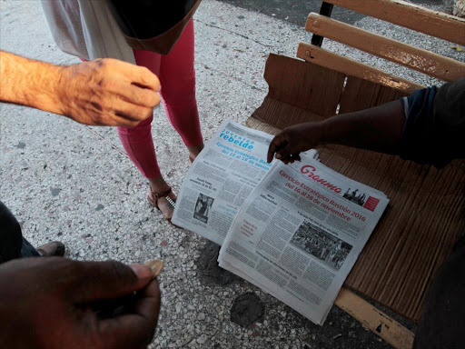 People buy local dailies with the headlines reading " Strategic exercise Bastion 2016 from November 16 to 18" announcing a week of pre-scheduled nationwide military exercises to prepare for "enemy actions", the day after the United States elected as president Donald Trump, in Havana, Cuba, November 9, 2016. /REUTERS