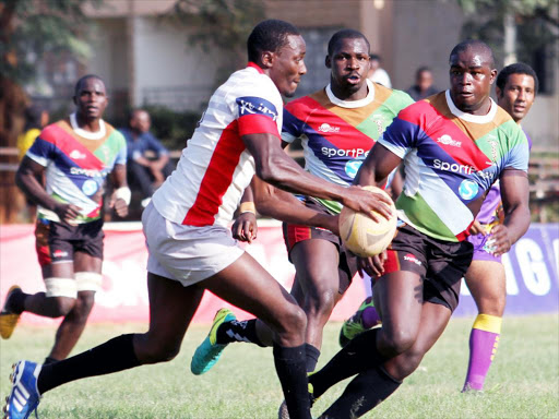 Impala's Antony Nyandigisi challenges Quins Isaac Adimo and Patrice Agunda during a Kenya Cup match.JPG