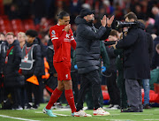 Liverpool manager Juergen Klopp and defender Virgil van Dijk react after theirs Premier League match against Manchester United at Anfield in Liverpool on Sunday.