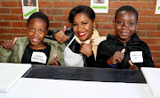 Pearl Ntshehi (center) with Dowling Primary School learners Uhone Musetsho and Sibusiso Moyo