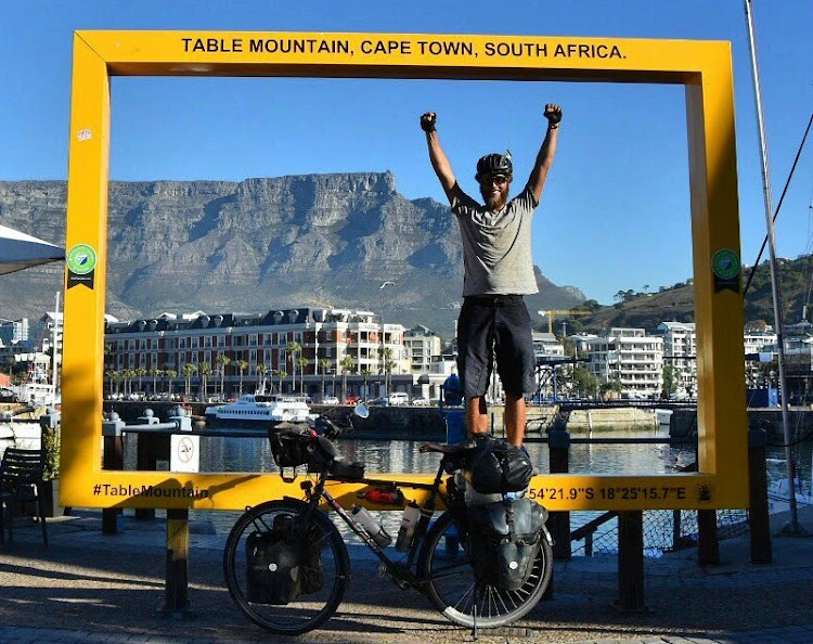 Lukas Steiner celebrates after his 326-day ride from Zurich to Cape Town ended on Friday May 10.