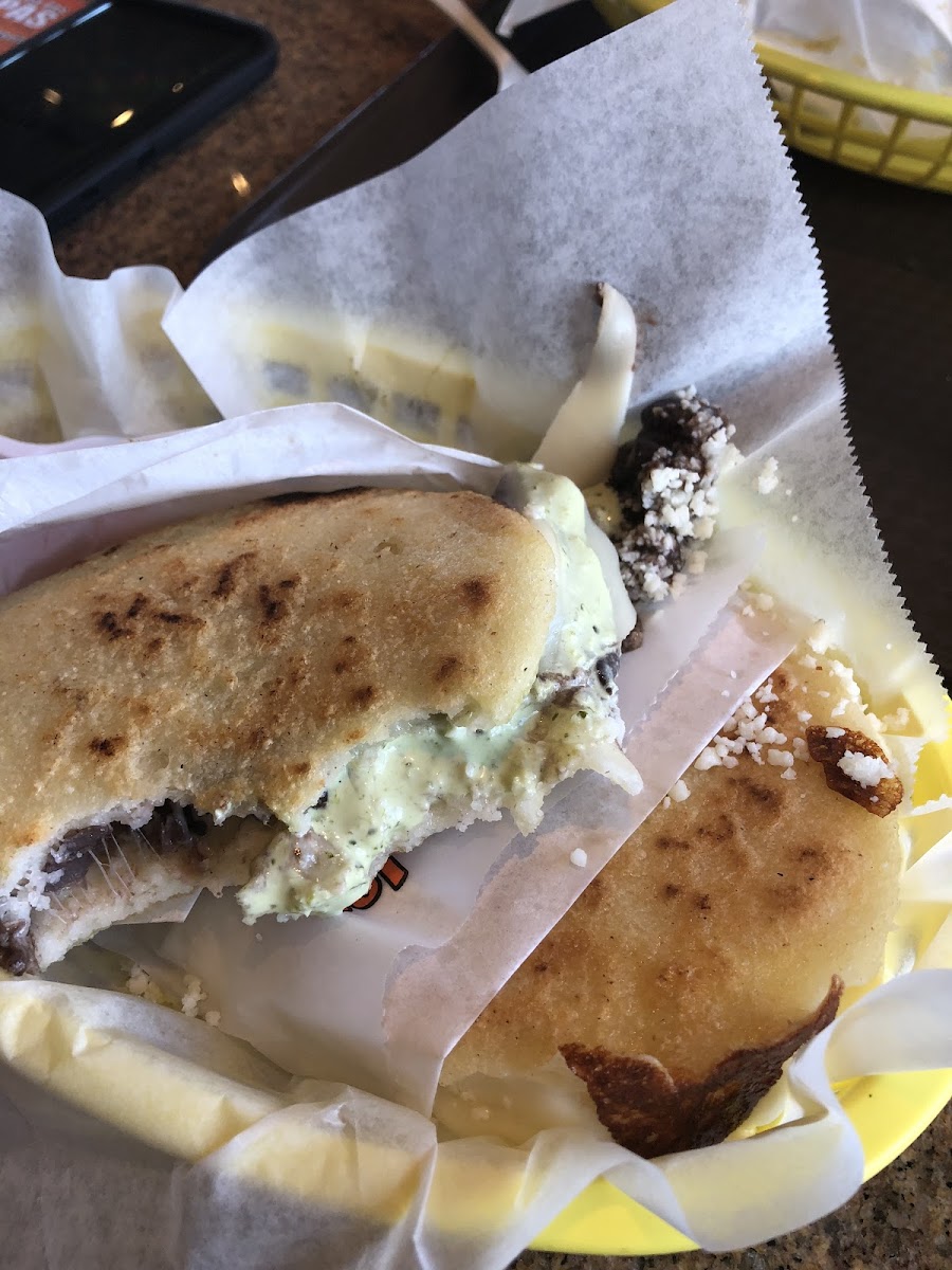 Black bean and cheese arepa with the yummy creamy green sauce.  Delish!