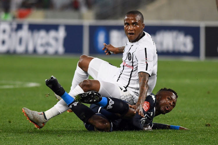 Thembinkosi Lorch of Orlando Pirates lands on Thabang Monare of Bidvest Wits during the Absa Premiership match between Bidvest Wits and Orlando Pirates at Moses Mabhida Stadium on September 21, 2019 in Durban, South Africa.