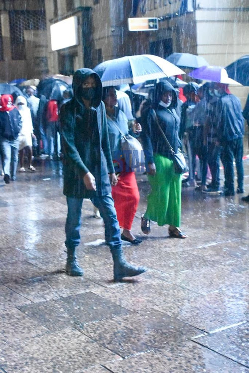 City dwellers walk to various destinations as some are seen being rained on without umbrellas on 18, January 2022./