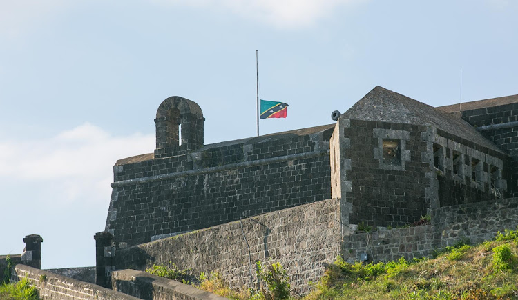 The St. Kitts flag flies at half staff over Brimstone Hill Fortress on St. Kitts. 