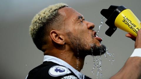 Newcastle United's Joelinton takes water during a past match