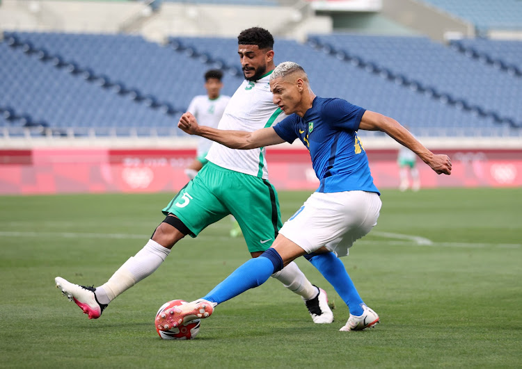 Richarlison of Brazil in action with Abdulelah Alamri of Saudi Arabia