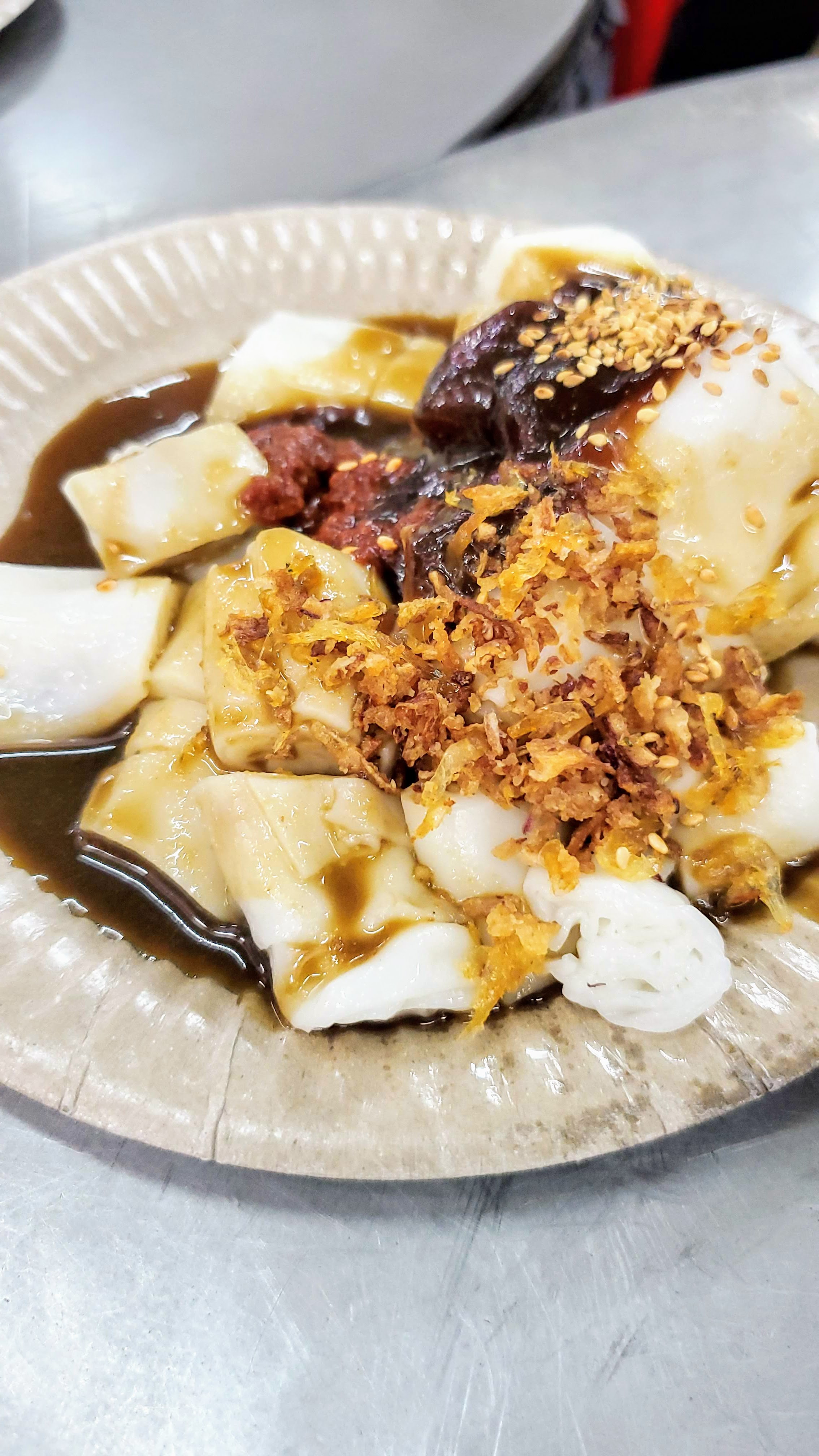 Food Highlights of Penang: Chee Cheong Fun, a rice noodle roll dish topped with the dark prawn paste and chili