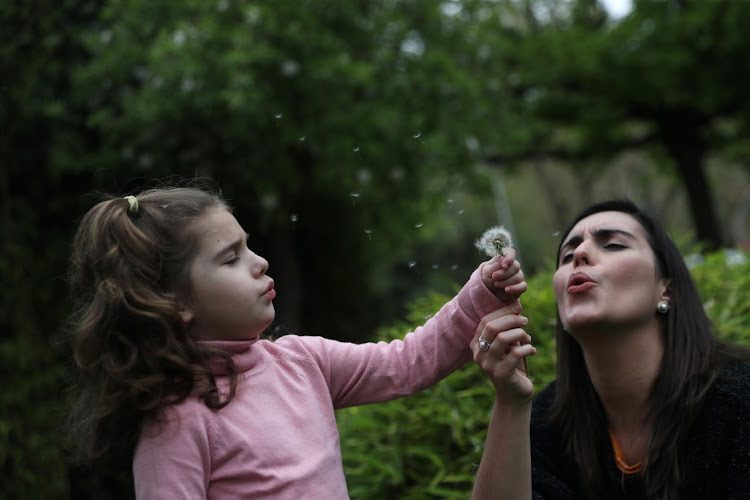 THROUGH HER SENSES: Susana Cristo plays with her daughter Olivia, a 4-year-old on the autism spectrum, next to a closed playground during the lockdown amid the coronavirus disease outbreak in Madrid, Spain, April 9