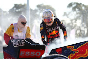 Max Verstappen and a track marshal tend to the fire in his car after he retired from the race during the F1 Grand Prix of Australia at Melbourne Grand Prix Circuit on April 10, 2022 in Melbourne, Australia.