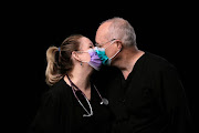 Jozette Dansk and David Dansk, who are married and are both charge nurses in the ICU and telemetry unit, kiss while posing for a portrait at the Swedish Medical Center Issaquah campus during the Covid-19 outbreak, in Issaquah, Washington, US, on April 21 2020. 