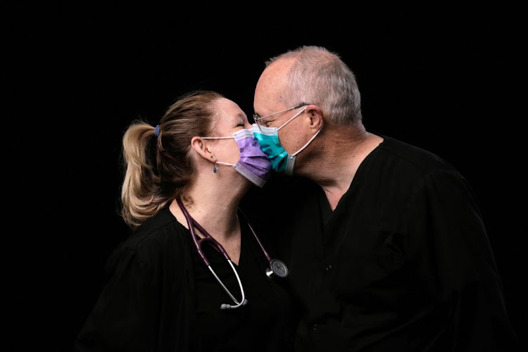 Jozette Dansk and David Dansk, who are married and are both charge nurses in the ICU and telemetry unit, kiss while posing for a portrait at the Swedish Medical Center Issaquah campus during the Covid-19 outbreak, in Issaquah, Washington, US, on April 21 2020. "Thank you to our community for all your support," they say.