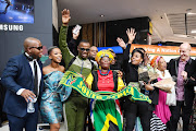 Zakes Bantwini, Wouter Kellerman and Nomcebo Zikode with fans at OR Tambo International Airport.