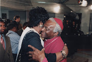 Desmond Tutu embraces Winnie Madikizela-Mandela.