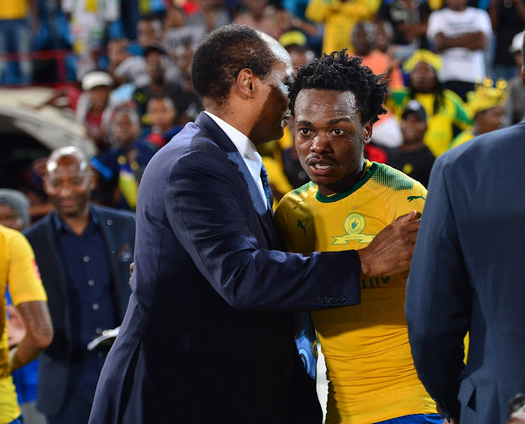 Mamelodi Sundowns' president and owner Patrice Motsepe (L) celebrates a victory with star forward Percy Tau during the Absa Premiership match against Maritzburg United at Loftus Stadium, Pretoria on December 13 2017.