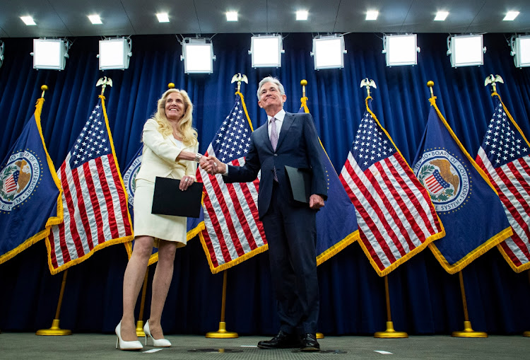 US Federal Reserve chair Jerome Powell, right, shakes hands with Lael Brainard, Fed vice-chair, following taking the oath of office during a ceremony in Washington, DC, the US, May 23 2022. Picture: AL DRAGO/BLOOMBERG